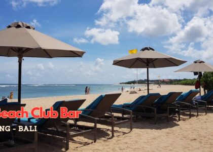 Beachfront seating at The Beach Club Bar with ocean views and tropical cocktails in Nusa Dua, Bali.